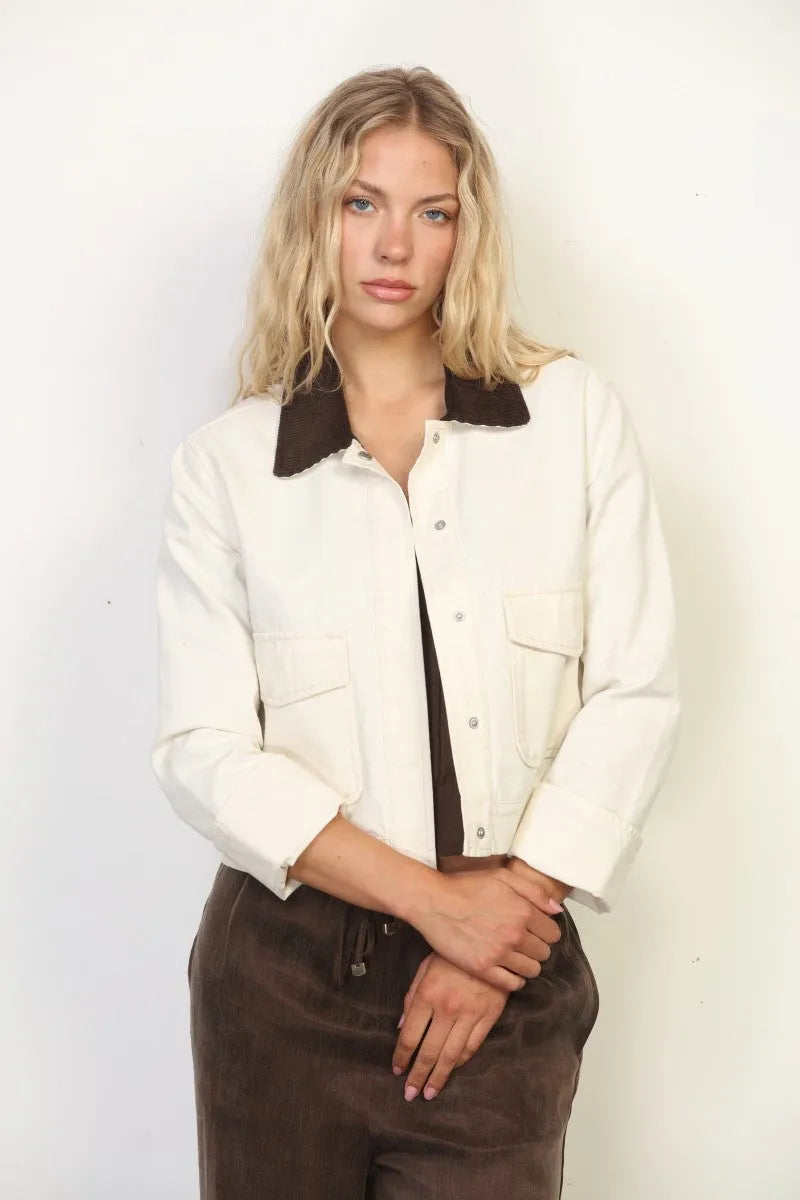 Cream-colored garment faded wash canvas barn jacket with contrasting dark brown collar and flap pockets