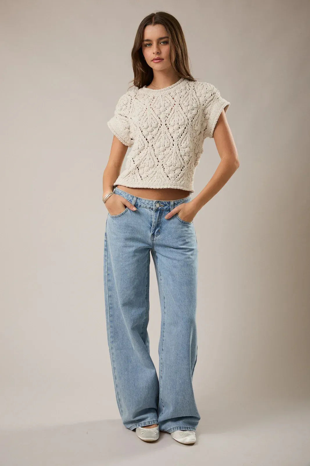 Cream-colored extended shoulder sweater top with cropped knit design short sleeves and diamond-patterned texture