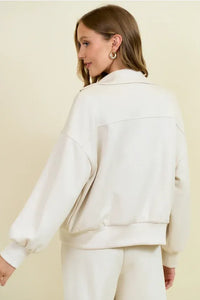 Cream-colored buttery soft flap pocket jacket in faux leather with a relaxed fit and ribbed cuffs