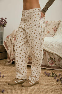 Cream-colored wide-leg floral denim pattern jeans with soft flowing fabric and subtle brown flower details