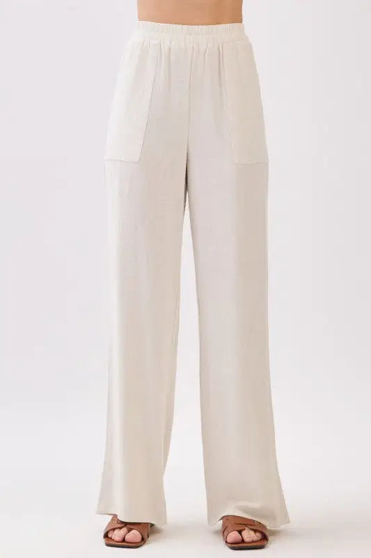 Cream-colored regular fit crosshatch pants featuring high-waisted wide-leg design with soft fabric and large patch pockets