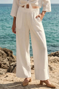 Cream-colored linen blend wide leg pants with elastic waistband and side pockets featuring soft hand feel