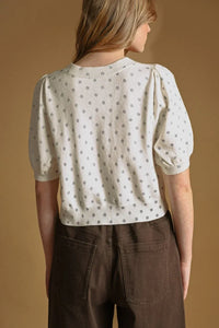 Cream-colored knit polka dot short sleeve cardigan with puffed sleeves and subtle gray pattern for casual wear