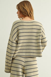 Cream-colored knit striped pattern long sleeve sweater with black horizontal stripes and relaxed cropped fit
