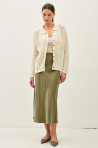 Cream-colored breezy textured knit cardigan with buttons and collar
