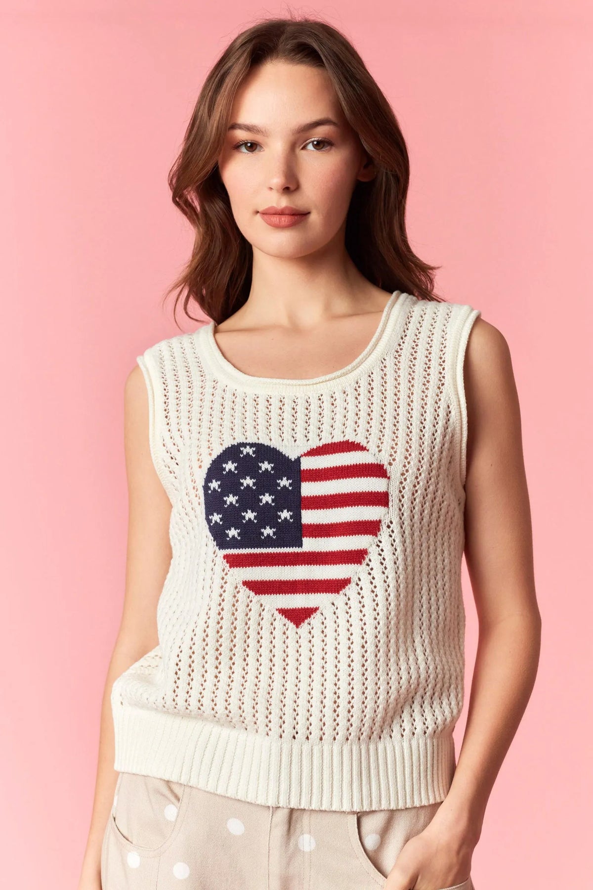 Cream-colored knitted sleeveless heart of america pointelle knit top featuring a heart-shaped american flag design