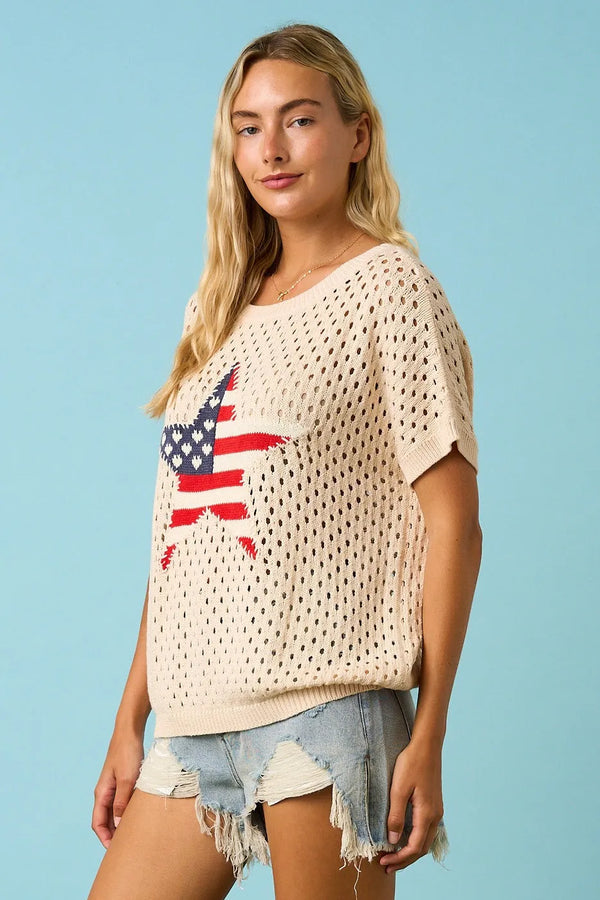 Cream-colored knitted sweater top with usa star patch featuring perforated star patch open knit design