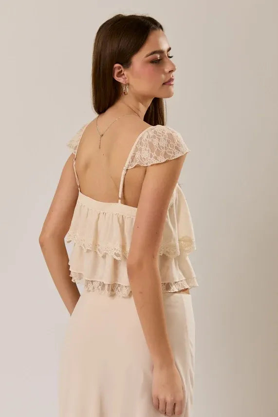 Cream-colored lace trim layered off-shoulder crop top with ruffled layers and delicate spaghetti straps