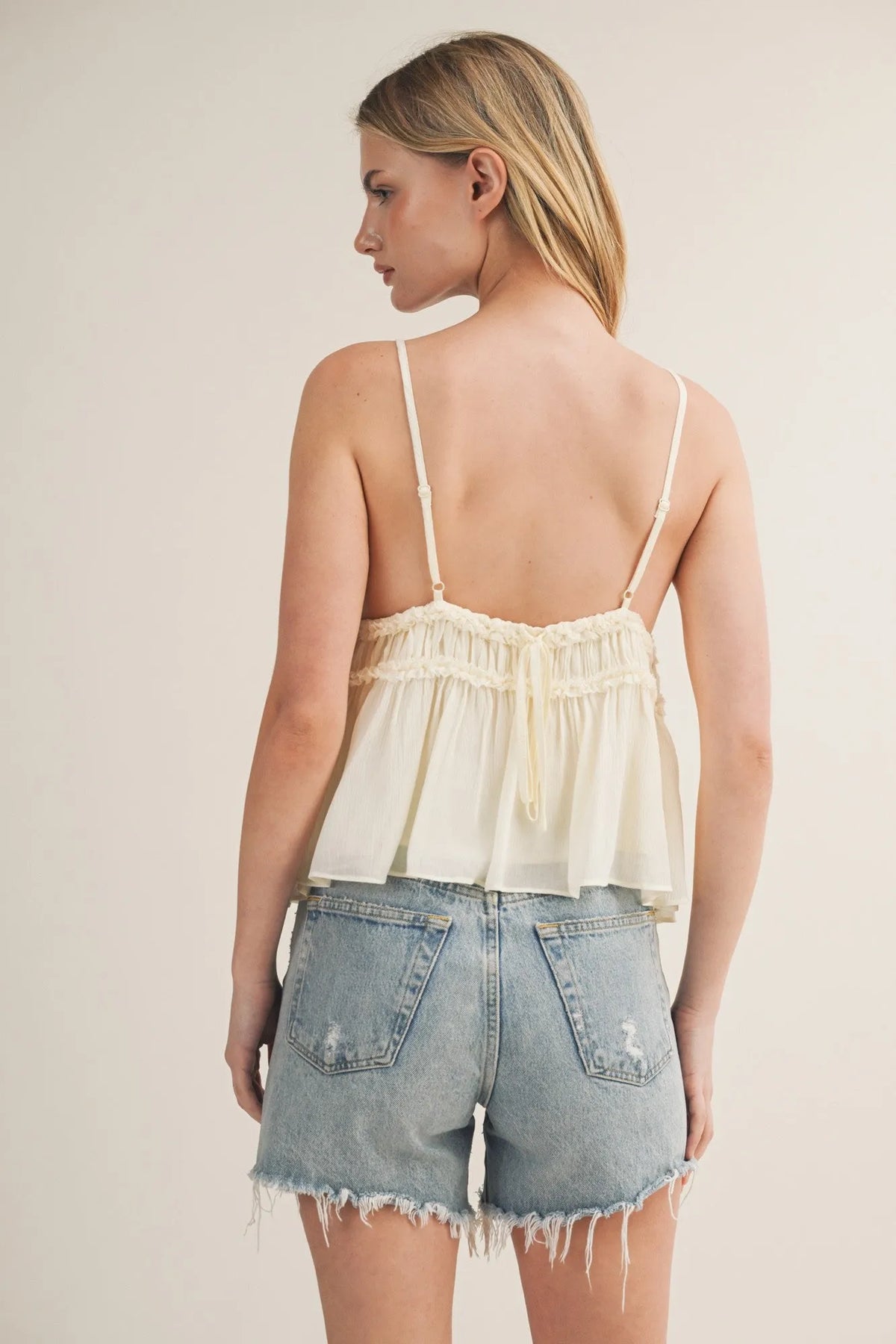 Cream-colored lightweight chiffon camisole with tiered ruffle bodice and delicate ruffled detailing and thin straps