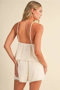 Cream-colored gauze picot lace v neck camisole with lightweight cotton, delicate spaghetti straps, and tiered ruffle hem