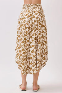 A flowing cream-colored midi skirt with delicate brown floral pattern and smocked waistband for comfortable fit