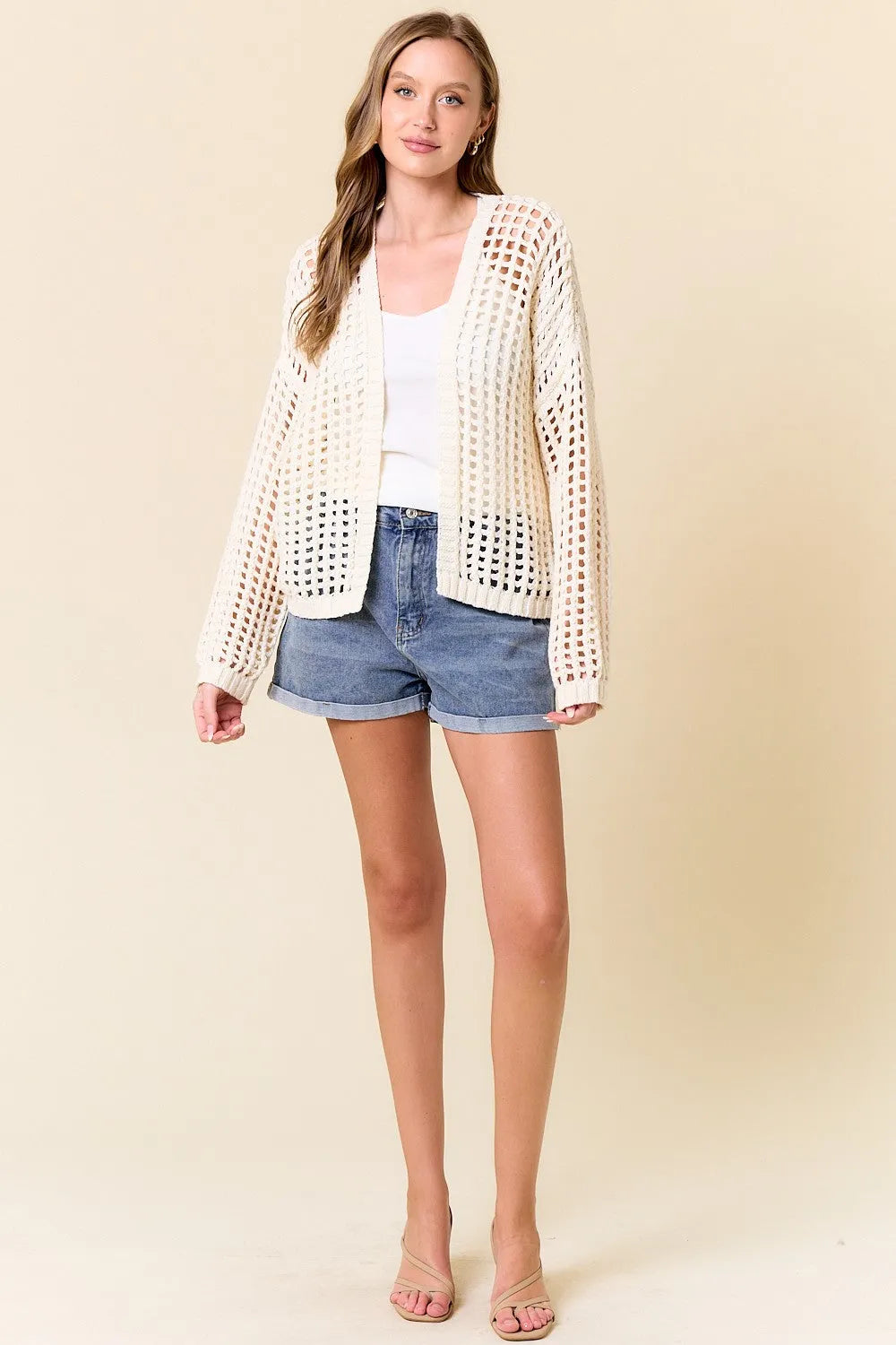 Cream-colored crochet fishnet cropped open cardigan with textured crochet fishnet pattern and open-knit design