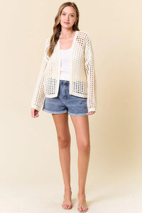 Cream-colored crochet fishnet cropped open cardigan with textured crochet fishnet pattern and open-knit design