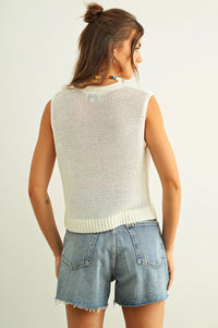 A cream-colored sleeveless round neck knitted top with an open-knit design and ribbed hem
