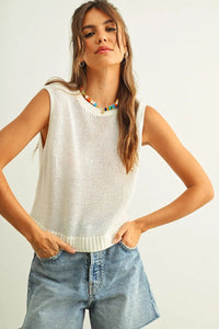 Cream-colored sleeveless round neck knitted top with open-knit design and ribbed hem for stylish layering