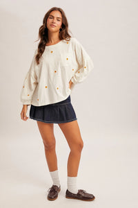 Daisy embroidered long sleeve top in cream with yellow daisies