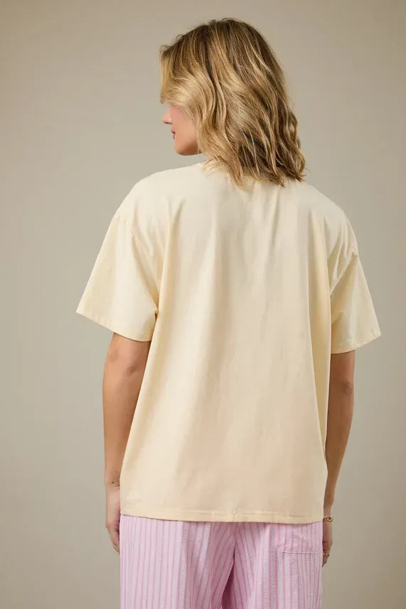 Cream-colored oversized cotton papaya crew neck graphic t-shirt with relaxed fit and short sleeves