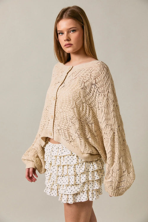 Cream-colored long sleeve crochet cardigan with intricate cable and lace patterns in oversized knit design