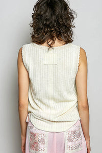 Cream-colored rib tank with textured rib knit fabric scalloped neckline and small rectangular patch on back side