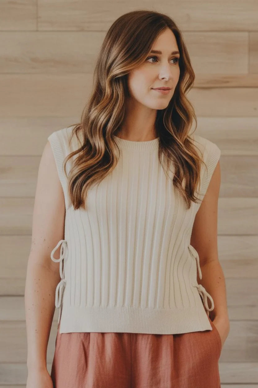 Cream-colored ribbed sweater vest with side ties by Thread & Supply