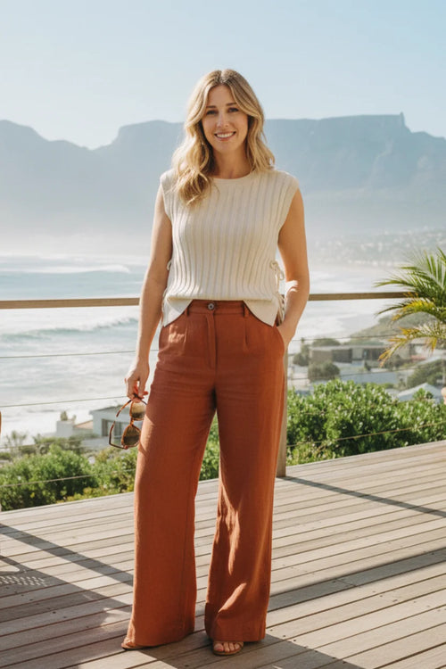 Cream-colored ribbed sweater vest with relaxed fit and side ties