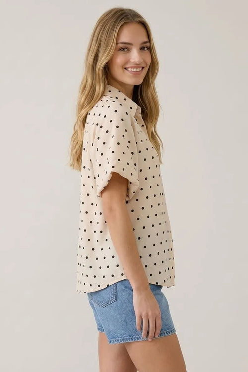 Cream-colored short-sleeved blouse with black polka dot bubble sleeves perfect for casual and formal wear