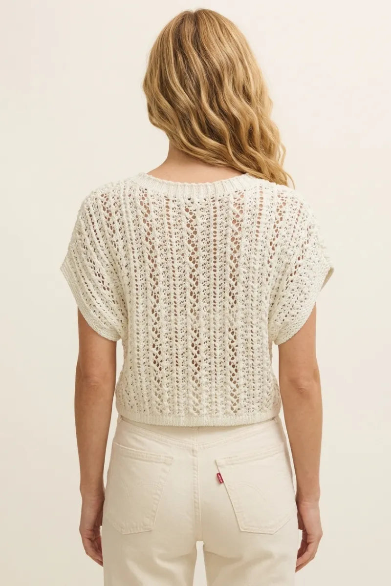 Cream-colored short-sleeved ballast crochet sweater top with openwork pattern and ribbed neckline in knitted fabric