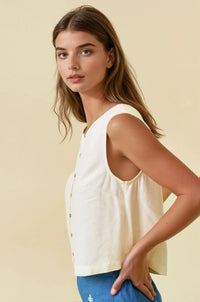 Cream-colored sleeveless viscose blend button front top with relaxed fit and subtle texture for casual wear