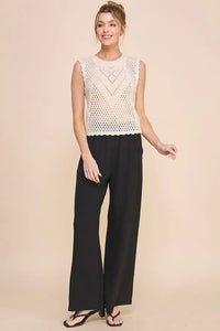 Cream-colored sleeveless crochet top with scallop pointelle round neck and geometric scalloped hem pattern