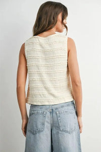 Cream-colored sleeveless textured button top with horizontal ruched detailing for women’s boho chic clothing