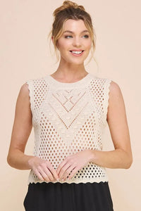 Cream-colored sleeveless knit scallop pointelle round neck top with scalloped edge and intricate geometric lace pattern