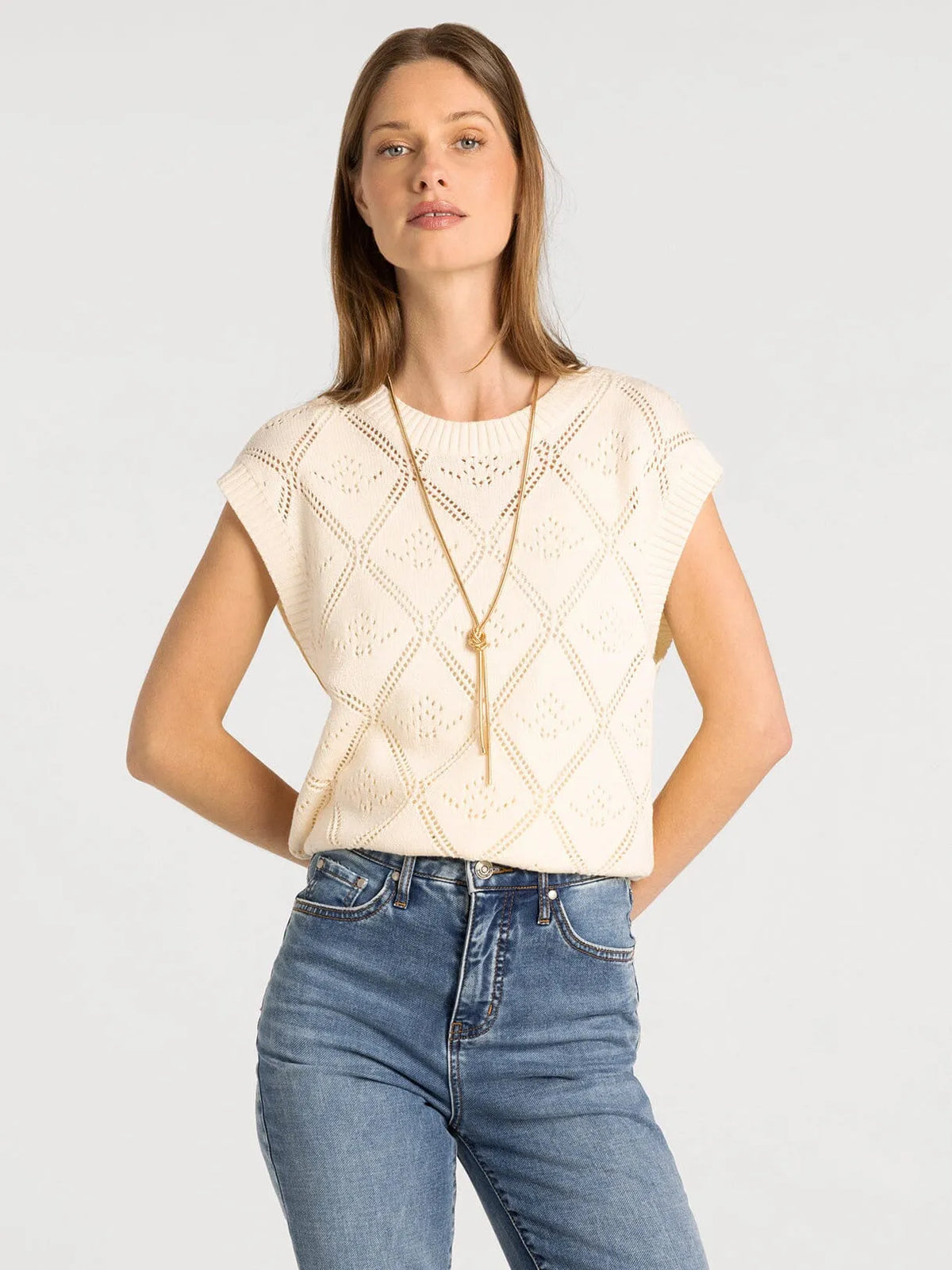 Cream-colored sleeveless knit percy sweater vest with diamond-patterned lace design by thread and supply