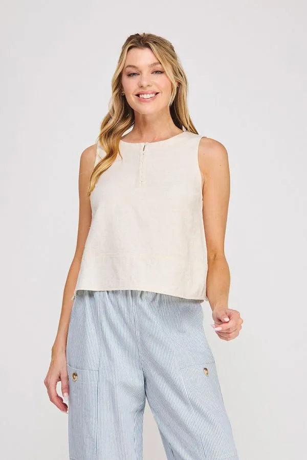 Cream-colored linen button collar textured sleeveless top with a subtle front zipper detail for elegant wear