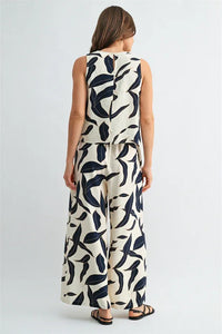 Cream-colored leaf print button sleeveless top and matching wide-leg pants set with bold navy blue leaf print for women’s boho style