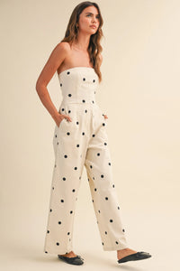 Cream-colored strapless wide leg jumpsuit with black polka dot stretch twill fabric and polka dot stretch design