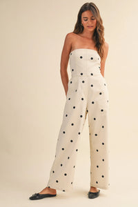 Cream-colored strapless wide leg jumpsuit with black polka dot stretch twill and fitted bodice design