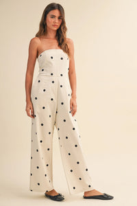 Cream-colored strapless wide leg jumpsuit with black polka dots made of polka dot stretch twill fabric