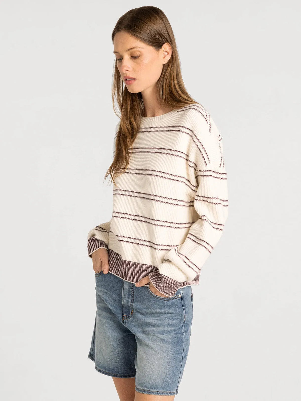 Cream-colored thread & supply ely sweater with thin black stripes and textured brownish-purple hem detailing