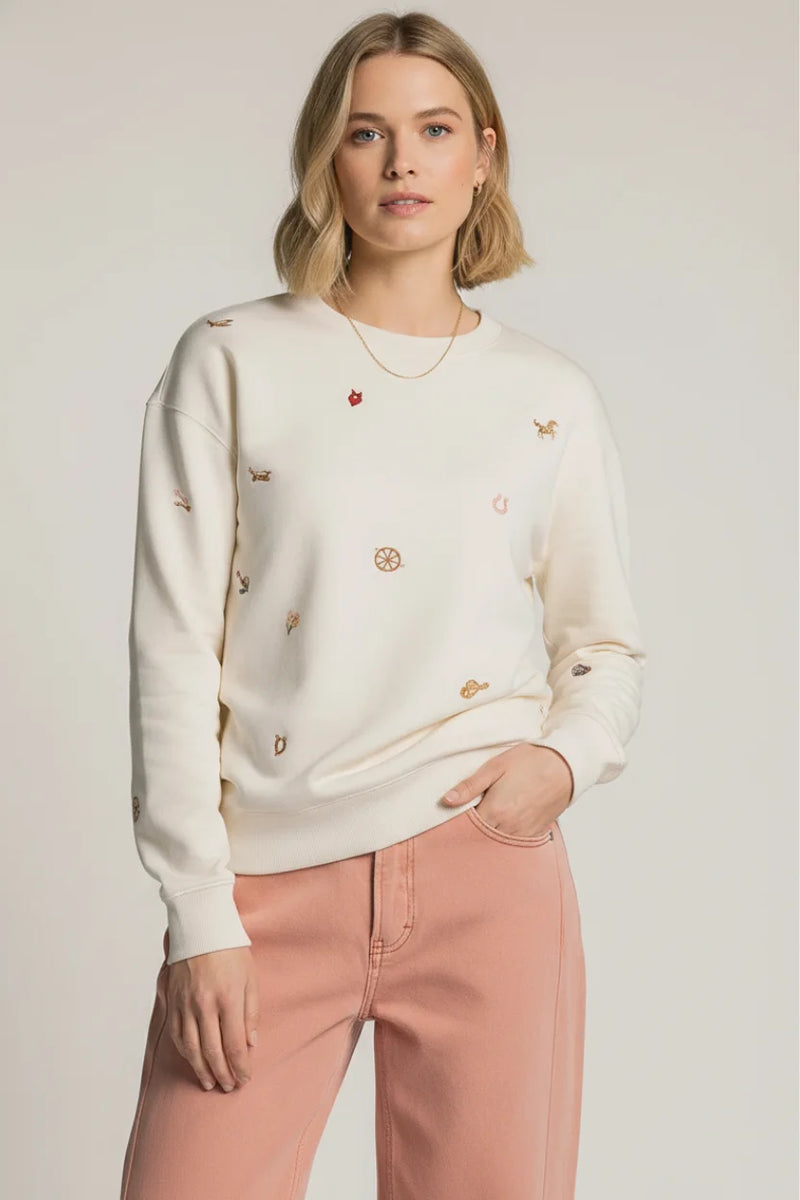 Cream-colored Thread & Supply road trip sweatshirt with gold and red embroidery