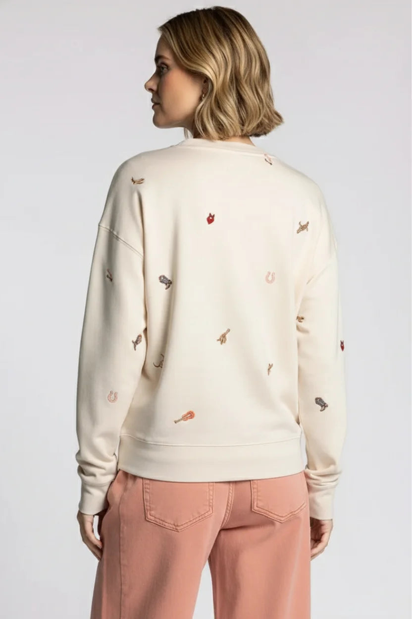 Cream-colored Thread & Supply road trip sweatshirt with embroidered motifs