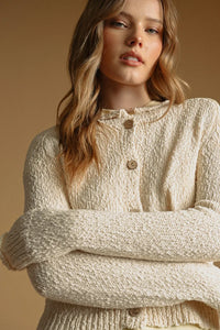 Cream-colored textured sweater knit cardigan with wooden buttons in button front sweater knit cardigan style