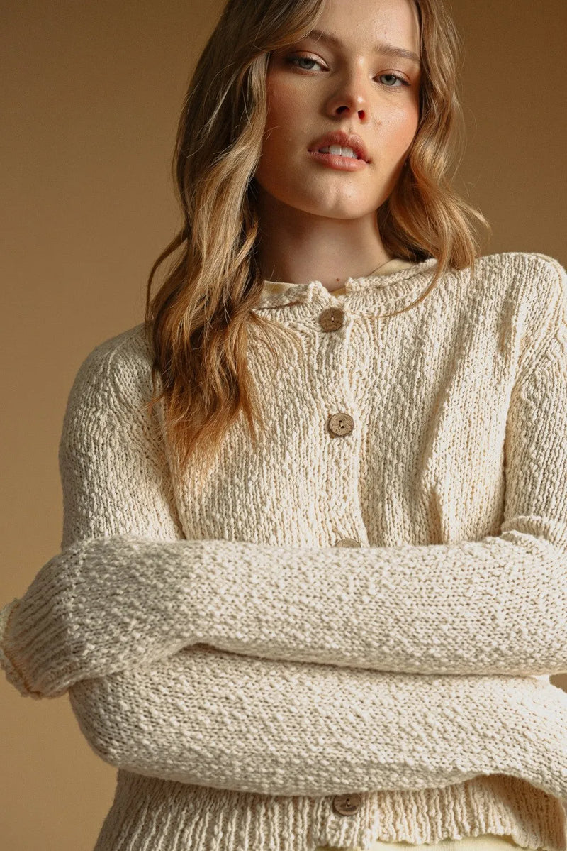 Cream-colored textured sweater knit cardigan with wooden buttons in button front sweater knit cardigan style