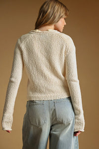 Cream-colored sweater knit cardigan with textured knit fabric and ribbed cuffs and hem for a cozy fit
