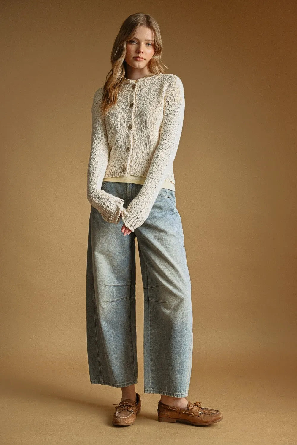 Cream-colored textured sweater knit cardigan with button front closure made from soft knit fabric