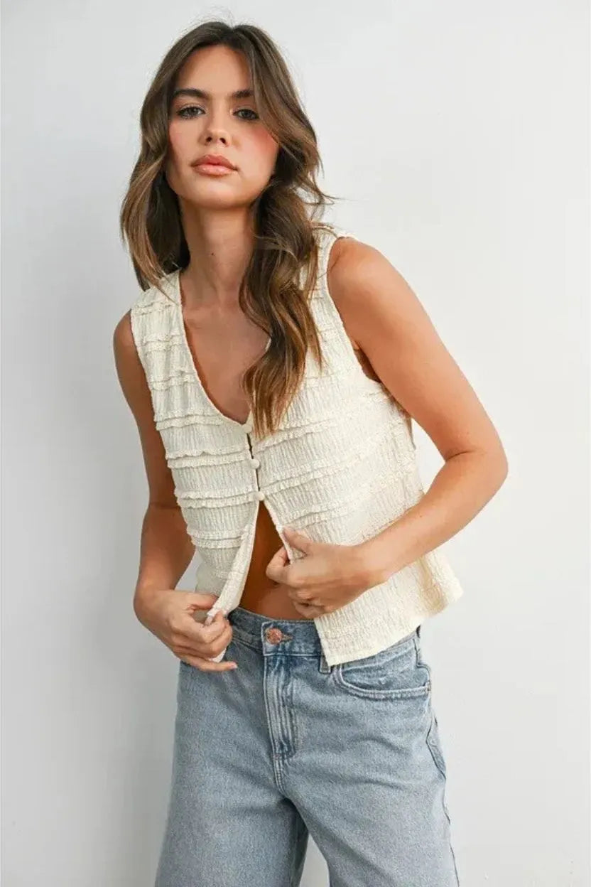 Cream-colored textured button front sleeveless top with ruched design and zipper closure for women’s boho chic clothing