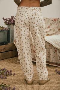 Cream-colored wide-leg jeans with a delicate muted floral denim pattern in brown and pink classic denim pattern jeans