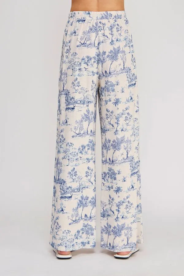 Cream-colored wide-leg pants with blue toile pastoral pattern featuring an elastic tie waist for comfort