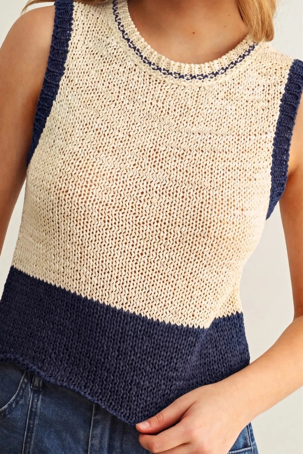 Color blocked sleeveless knitted top in cream and navy blue with textured open-knit body and ribbed trim