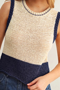 Color blocked sleeveless knitted top in cream and navy blue with textured open-knit body and ribbed trim