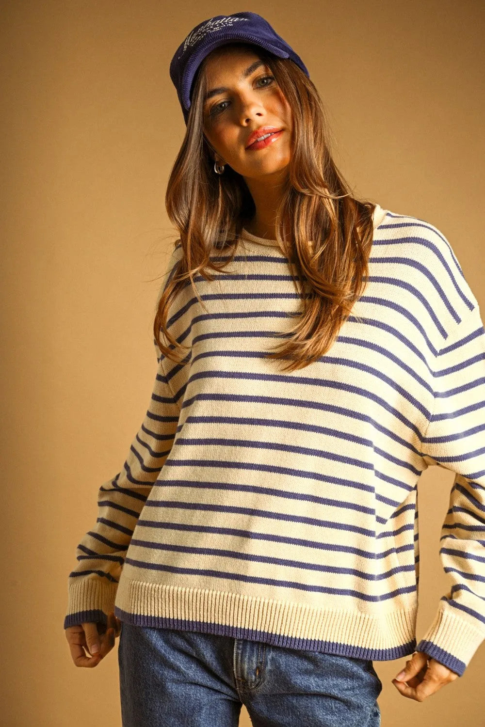 Cream and navy blue striped long sleeve knit sweater with ribbed cuffs and hem for casual wear